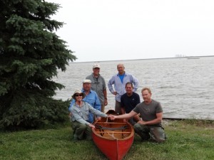 The crew celebrates the completion of their adventure at Pointe Mouillee with the waters of Great Lake Erie behind them